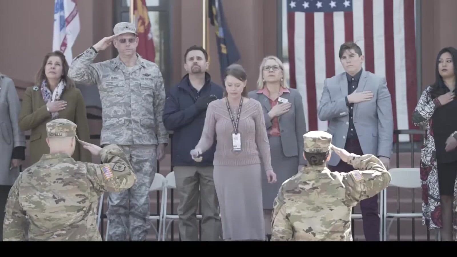 Salute line under American flags at the Reno VA Spartan Pledge event